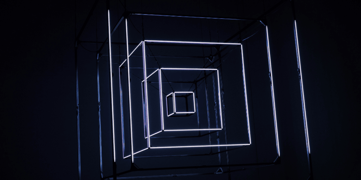 Glowing concentric neon cubes in a dark space